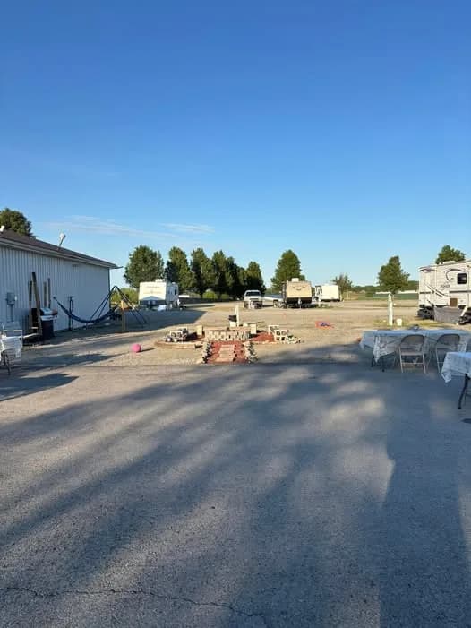 Tables and seating set up on the lot beside the shower house for a get-together at Heartland RV Park