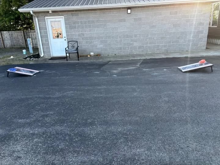 Cornhole boards set up on the recreation lawn at Heartland RV Park