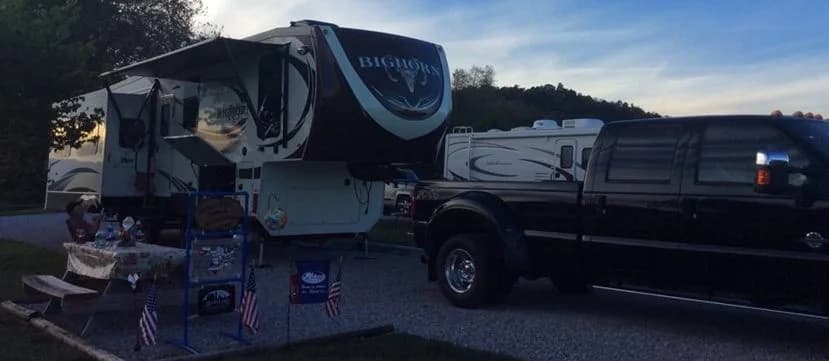 Bighorn fifth-wheel RV at sunset with seasonal decorations on a picnic table