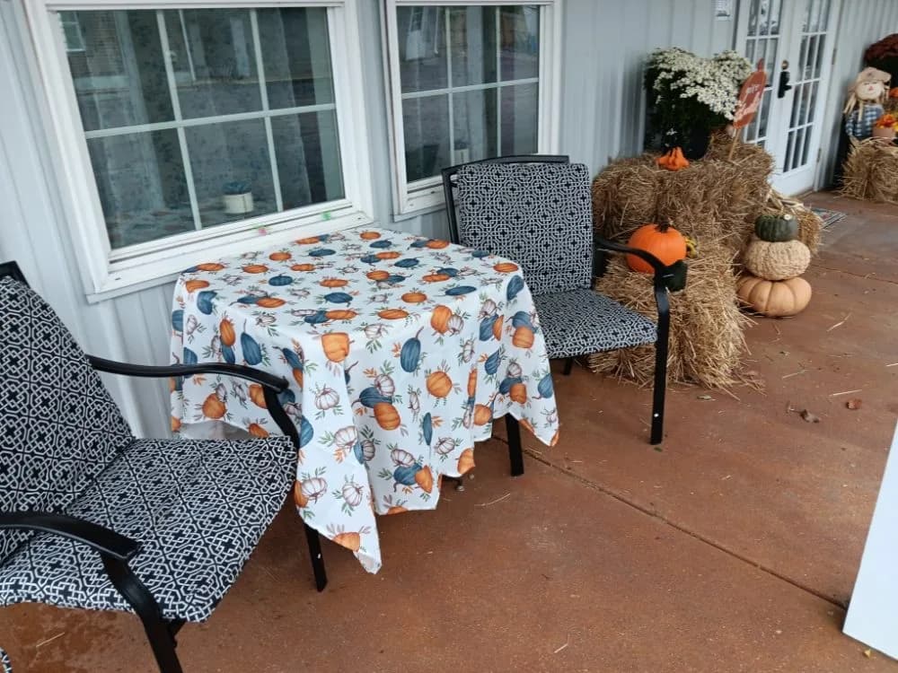 Welcome porch with hay bales and pumpkin-themed seasonal decor