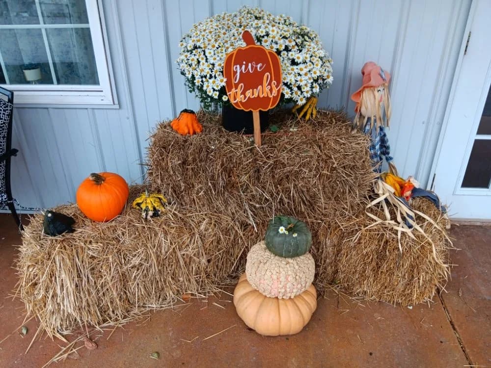 'Give thanks' pumpkin and scarecrow display with hay bales at Heartland RV Park